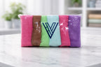 Packaged bundle row of multi-color Vorre basic 320 GSM microfiber cleaning cloths on a counter.
