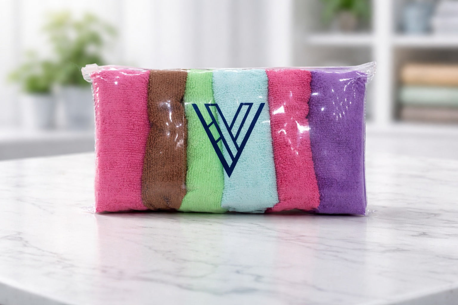 Packaged bundle row of multi-color Vorre basic 320 GSM microfiber cleaning cloths on a counter.