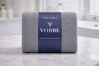 Packaged charcoal grey Vorre Blush microfiber bath towel wrapped with a signature dark blue brand sleeve label.