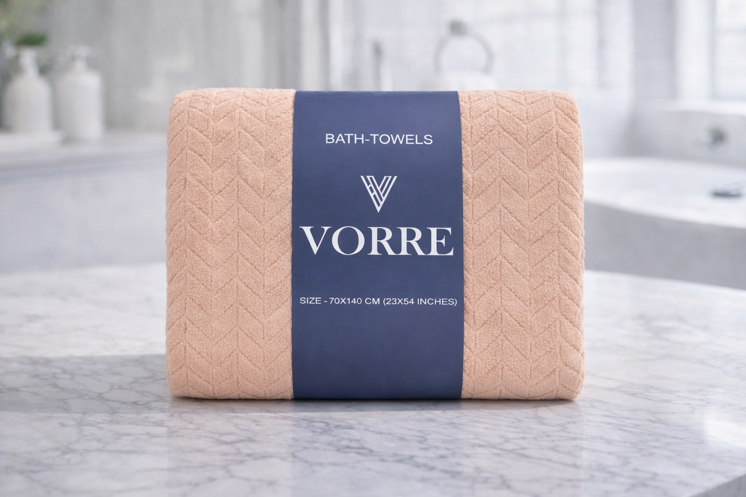 Packaged peach cream Vorre Blush microfiber bath towel folded cleanly with a dark blue luxury packaging wrapper.