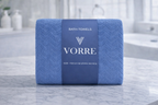 Packaged royal blue Vorre Blush microfiber bath towel wrapped securely with a premium branded label sleeve.