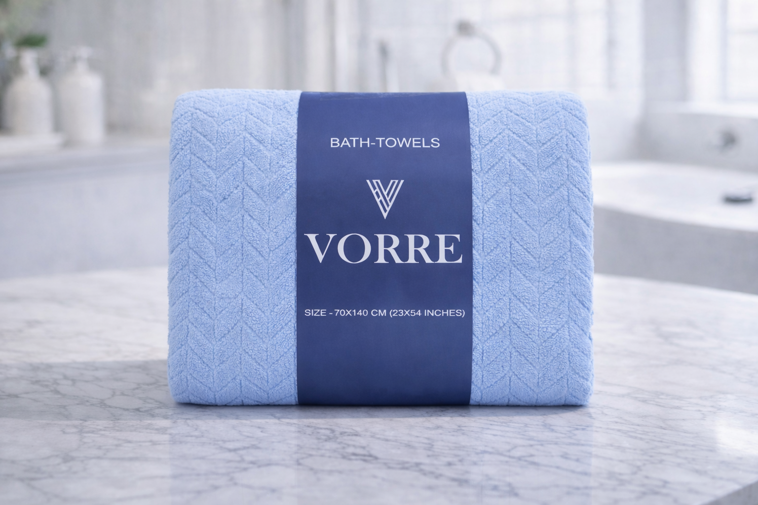 Packaged sky blue Vorre Blush textured microfiber bath towel featuring a premium branded navy blue belly band.