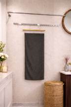 Charcoal grey Vorre Classic microfiber bath towel, durable high-absorbency 400 GSM daily use towel shown on a bathroom rack.