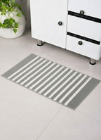 Grey and white horizon stripe micro polyester bathmat on a modern tiled bathroom floor.