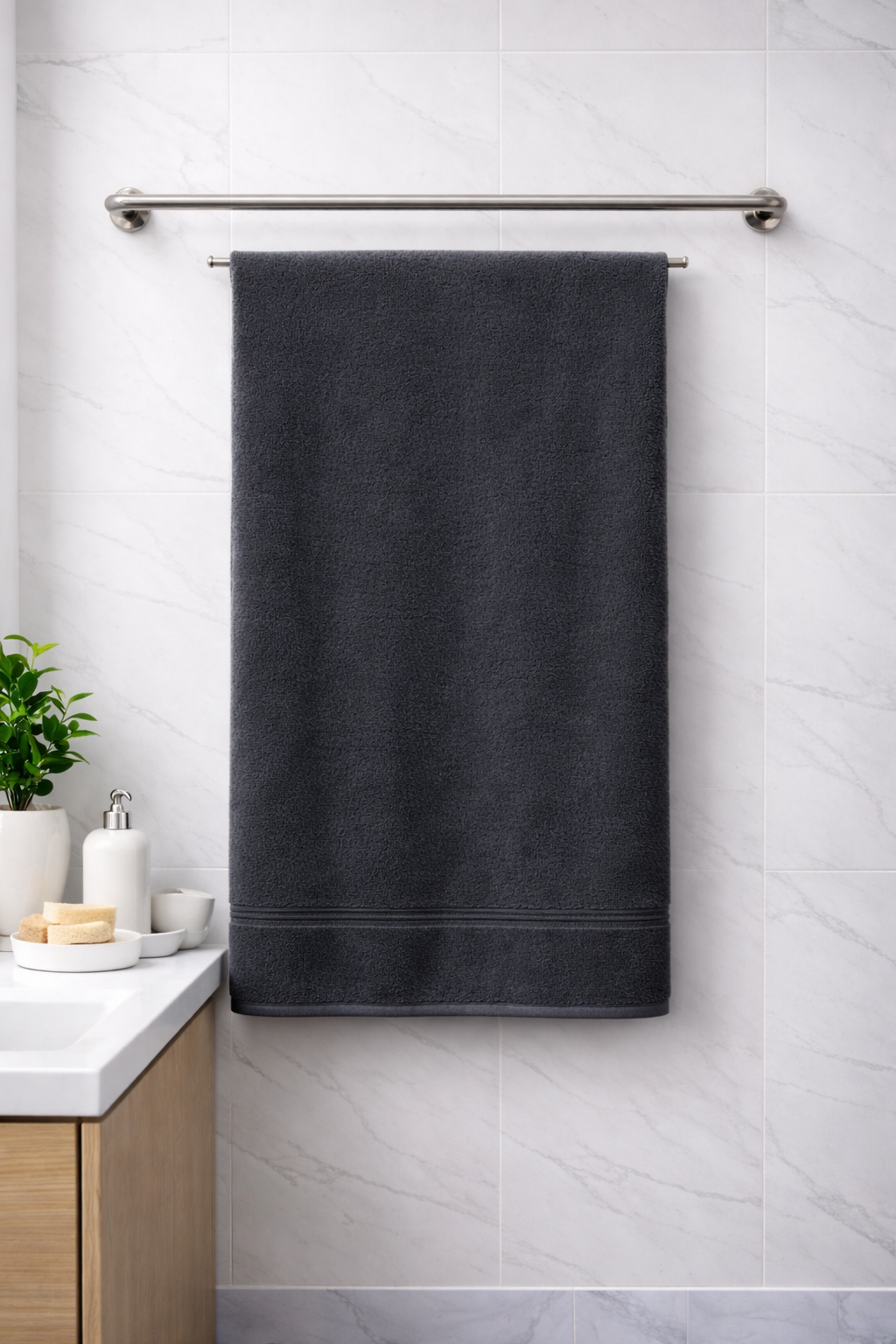 Charcoal grey Vorre Micro Border bath towel, absorbent 350 GSM quick-dry body towel hanging on a sleek bathroom rod.