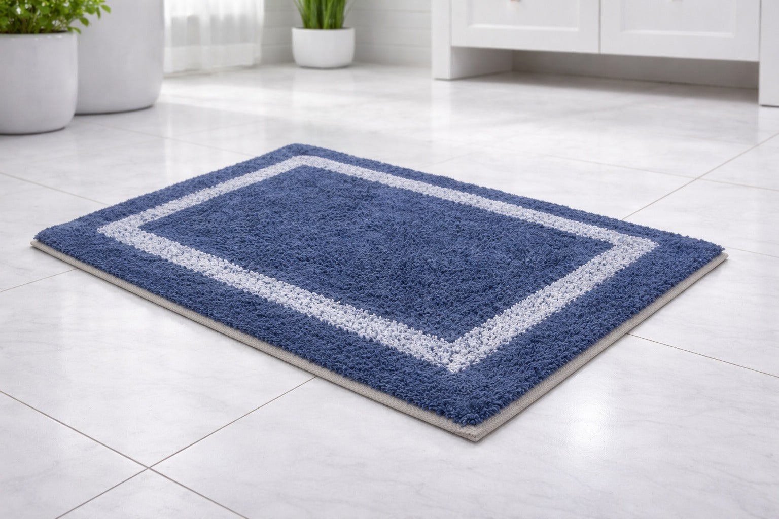 Navy blue rectangular bordered cotton mix bathmat, soft absorbent bathroom floor rug.