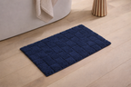 Navy blue grid texture micro polyester bathmat with non-slip rubber backing for bathroom floors.