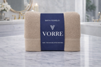 Packaged beige taupe Vorre Norvelle recycled cotton bath towel wrapped securely in a branded belly band.