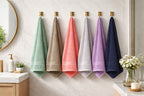 Vorre Norvelle 400 GSM recycled cotton hand towels in 6 assorted colors hanging on bathroom hooks.