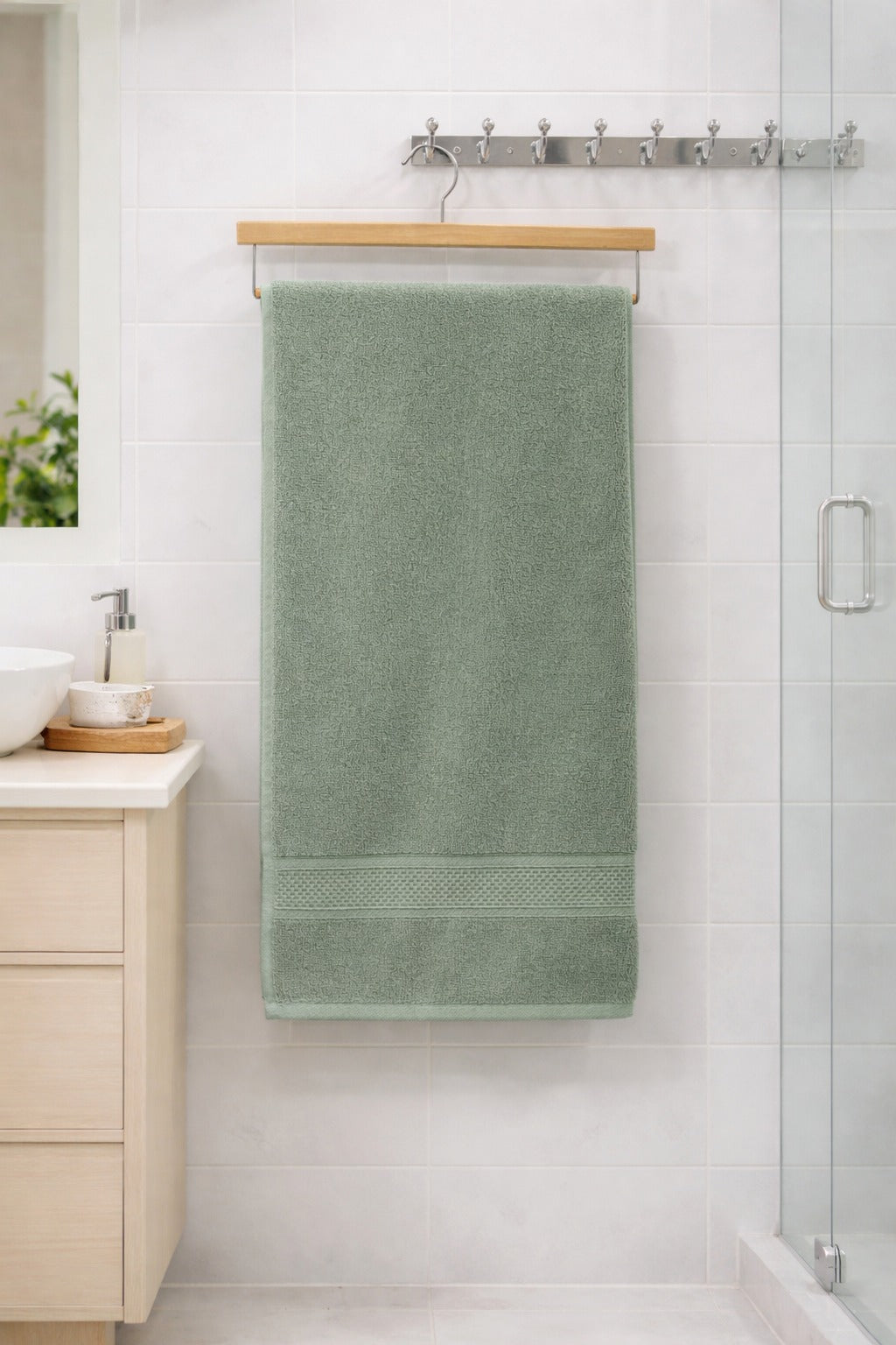 Sage green Vorre Norvelle eco-friendly recycled cotton bath towel, absorbent 400 GSM daily use towel displayed in a bright bathroom.