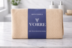 Packaged cream beige honeycomb pattern Vorre microfiber bath towel wrapped securely in a premium branded belly band.