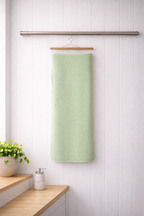 Muted mint green Vorre Pattern microfiber bath towel, lightweight absorbent 70x140 cm towel displayed in a bright interior.