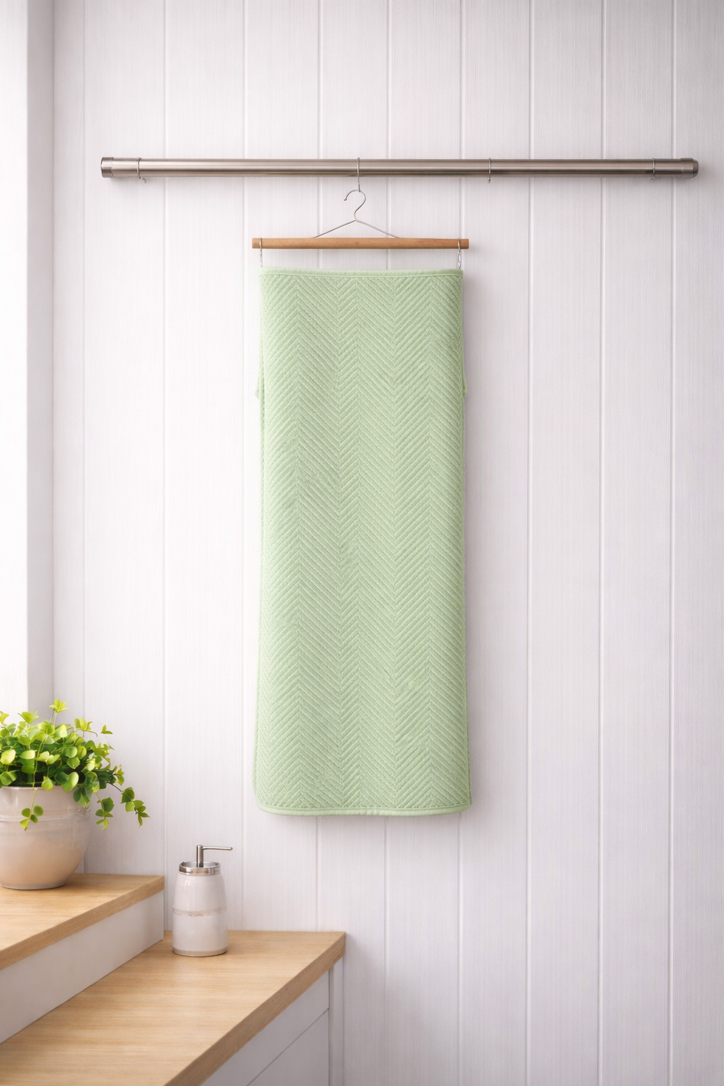 Muted mint green Vorre Pattern microfiber bath towel, lightweight absorbent 70x140 cm towel displayed in a bright interior.