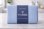 Packaged sky blue textured print Vorre microfiber bath towel showing a signature navy product wrapper band.
