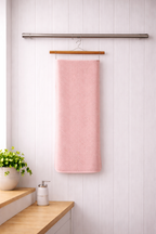 Soft pastel pink Vorre Pattern microfiber bath towel, highly absorbent everyday utility towel hanging neatly.