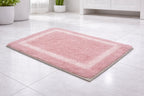 Pink mauve bordered cotton mix bathmat set of 2, soft breathable fabric underfoot.