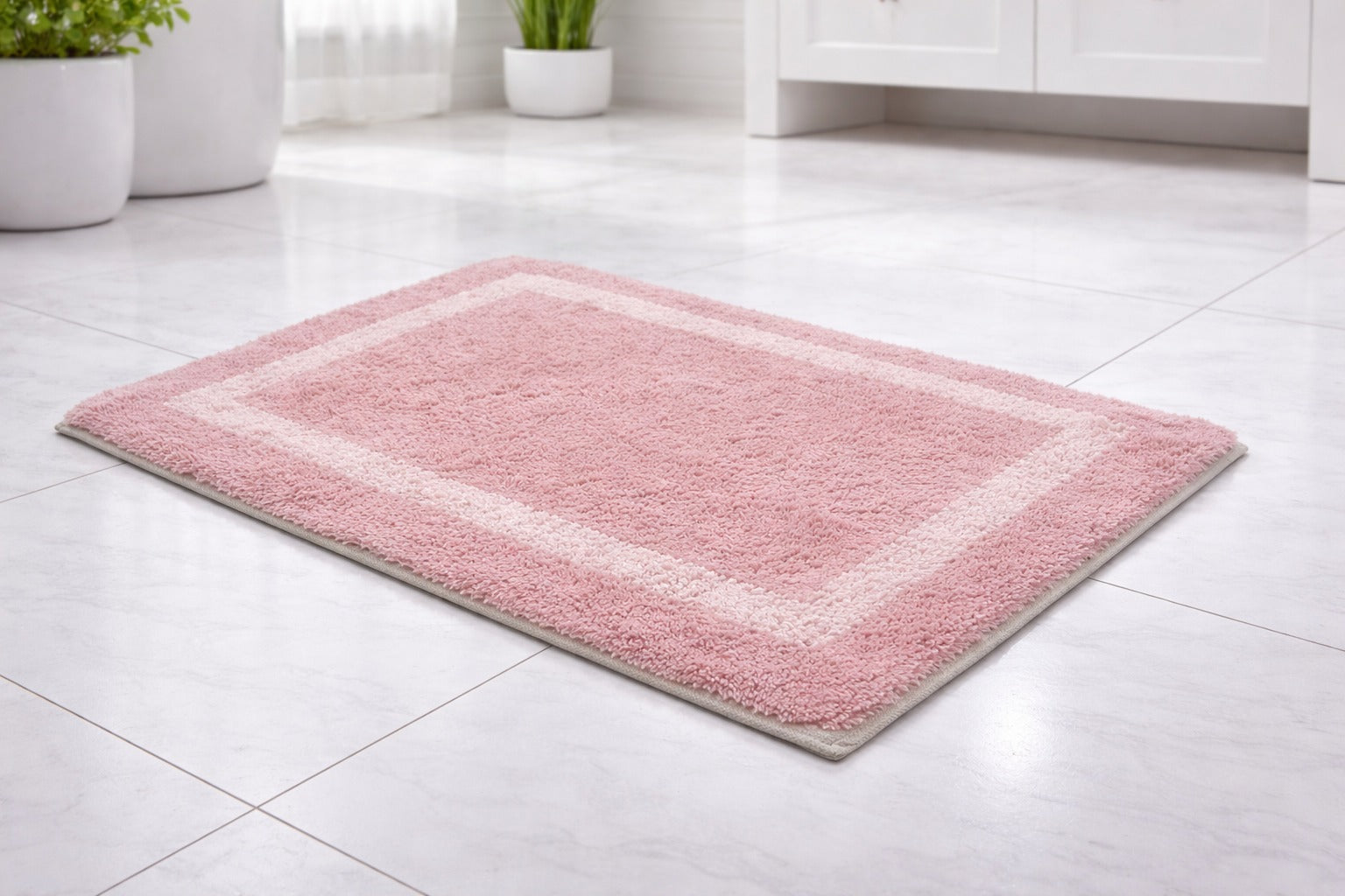 Pink mauve bordered cotton mix bathmat set of 2, soft breathable fabric underfoot.
