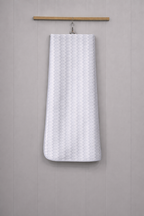 Classic grey and white zig-zag chevron Vorre microfiber bath towel, multi-purpose compact body sheet hanging on a rod.