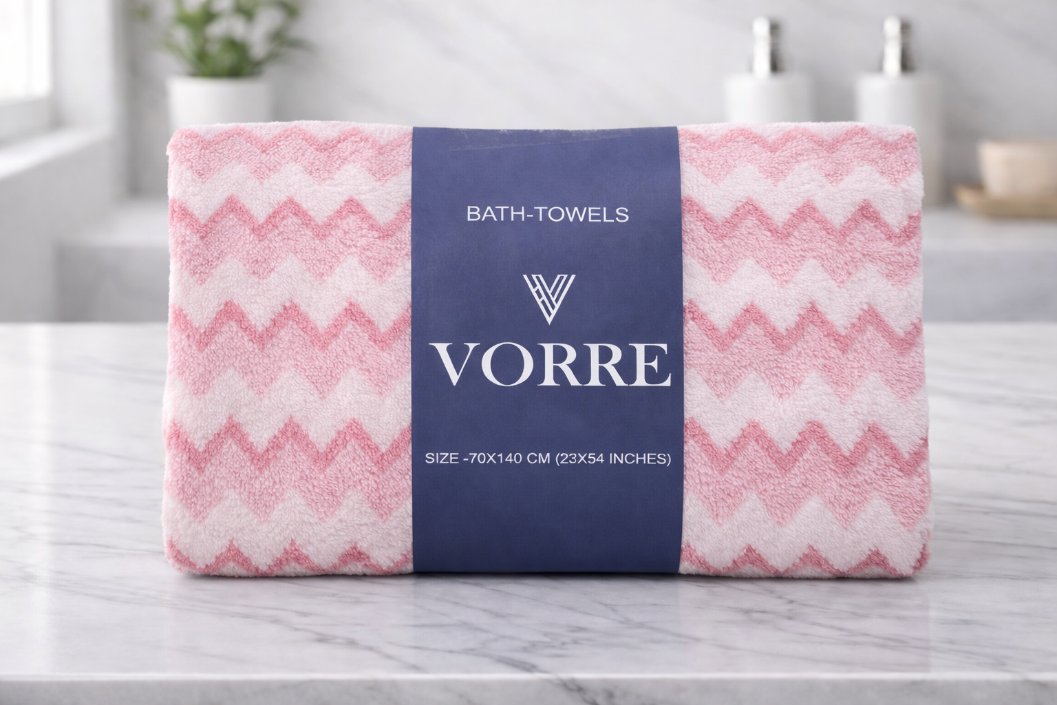 Packaged pink chevron pattern Vorre microfiber bath towel folded cleanly with a signature navy product wrapper band.