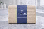 Packaged cream beige ribbed texture Vorre microfiber bath towel wrapped securely in a premium branded belly band.