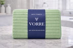 Muted mint green Vorre Ripped microfiber bath towel, lightweight absorbent 70x140 cm ribbed towel displayed in a bathroom.