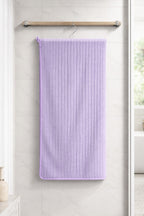 Lavender purple Vorre Ripped microfiber bath towel, 280 GSM quick-dry ribbed body towel hanging on a modern bathroom rod.
