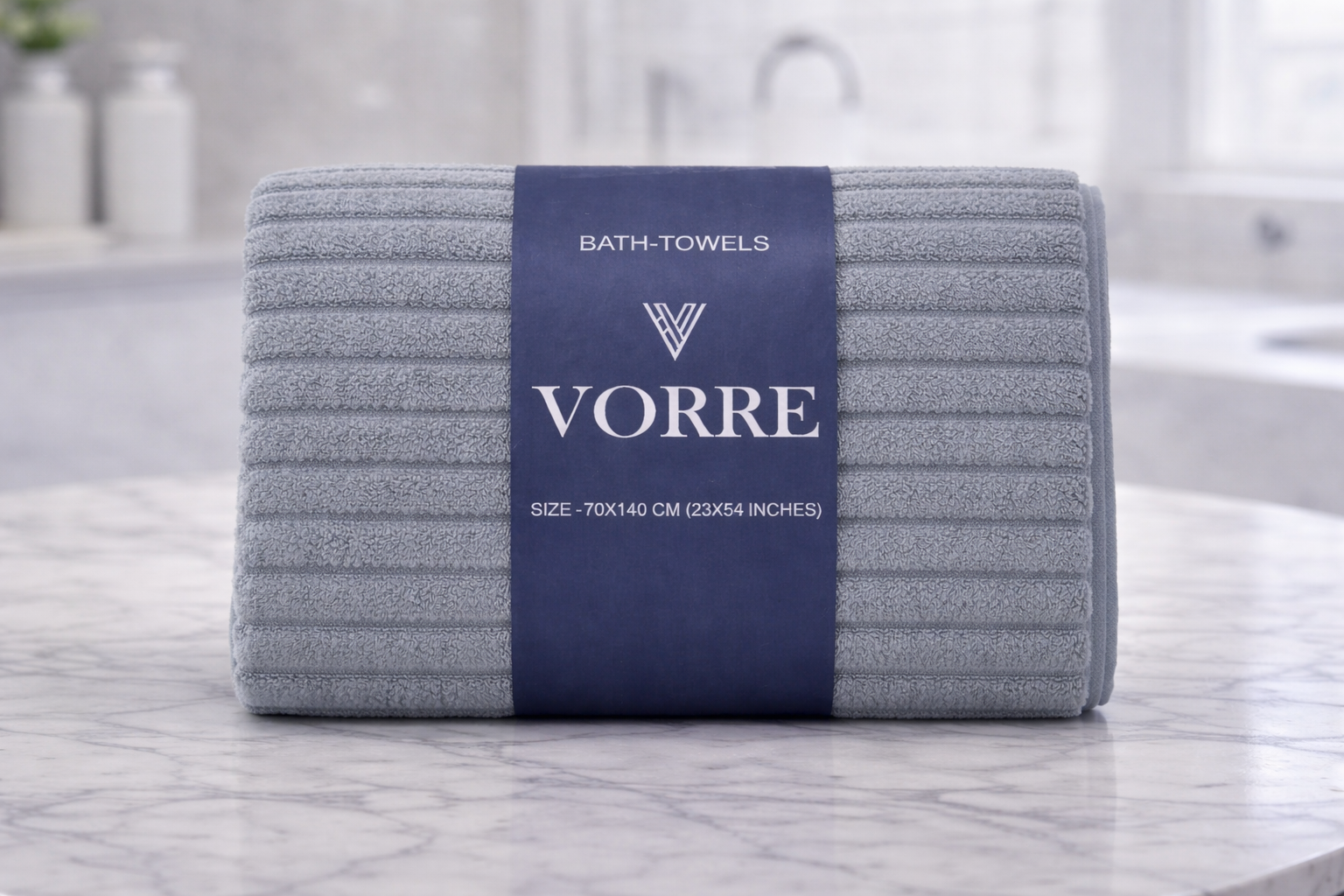 Packaged slate grey textured ribbed Vorre microfiber bath towel with a dark blue luxury paper wrapper sleeve.
