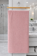 Soft pastel pink vertical ribbed Vorre microfiber bath towel, durable machine washable 280 GSM utility towel.