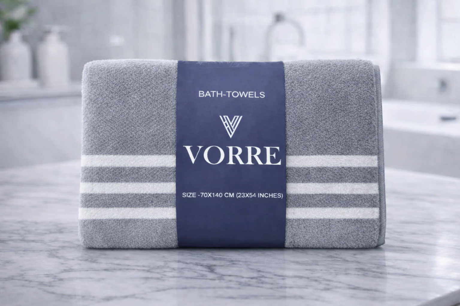 Packaged grey striped Vorre microfiber bath towel featuring a premium branded packaging sleeve on a marble counter.
