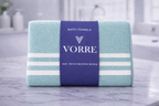 Packaged mint teal green striped Vorre microfiber bath towel displaying white stripe details and a dark blue brand sleeve.