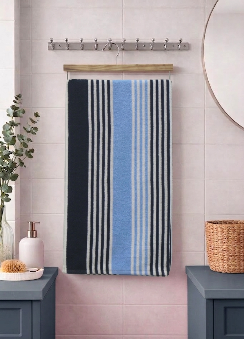 Navy blue, sky blue, and grey striped Vorre TNT micro polyester bath towel, compact absorbent utility towel hanging on a rod.