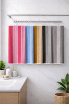 Multi-color palette display of Vorre TNT striped micro polyester bath towels showcasing pink, blue, grey, and ochre variants together.
